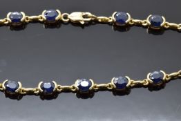 A 9ct gold bracelet set with oval sapphires, 7.8g