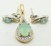 A 9ct gold pendant set with an oval cut Paraiba opal and diamonds and a pair of similar earrings,