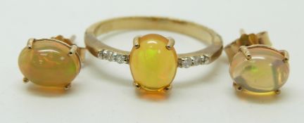 A 9ct gold ring set with an oval opal cabochon and diamonds (size N) with a pair of similar earrings