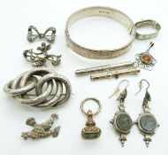 A silver bangle, Victorian knot brooch, Victorian white metal earrings set with agate, silver