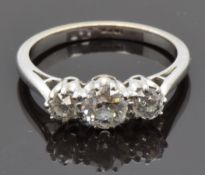 An 18ct white gold ring set with three round cut diamonds measuring approximately 0.6ct, 0.2ct & 0.