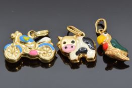 Three 9ct gold and enamel charms, one in the form of a cow, one a parrot and the other a