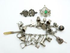 A silver/ white metal charm bracelet, continental silver brooch set with paste and a Victorian