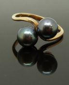 An 18ct gold ring set with two Tahitian black pearls, size O, 3.75g