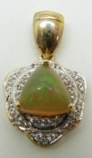 A 9ct gold pendant set with a trilliant cut Kalimaya opal surrounded by white sapphires, 4.2g
