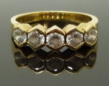 An 18ct gold ring set with five cubic zirconia, size Q, 5.29g