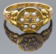 Victorian 15ct gold ring set with a diamond surrounded by seed pearls, the shoulders set with