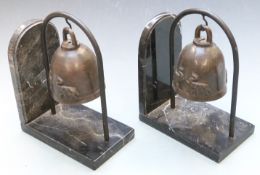 A pair of Art Deco style marble bookends with hanging Tibetan bells, height 26cm