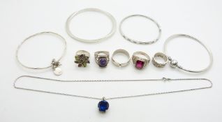 Four silver bangles, five silver rings, one set with a diamond, a silver pendant and chain