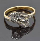 An 18ct gold ring set with two old cut diamonds, each approximately 0.35ct, and with diamond