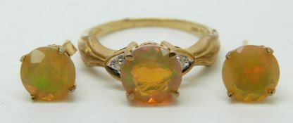 A 9ct gold ring set with a round cut Indonesian opal and diamonds (size N) with a pair of similar