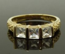 A 9ct gold ring set with three square cut paste, size N, 2.23g