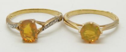 A 9ct gold ring set with a round cut Indonesian opal and a 9ct gold ring set with an oval cut