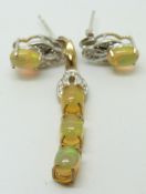 A 9ct gold pendant set with three oval Indonesian opals, with a pair of similar earrings