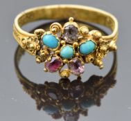 An early Victorian ring set with turquoise, topaz and quartz, with a pierced and filigree decoration