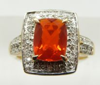 A 9ct gold ring set with a cushion cut Salamanca fire opal and diamonds, 4g, size M