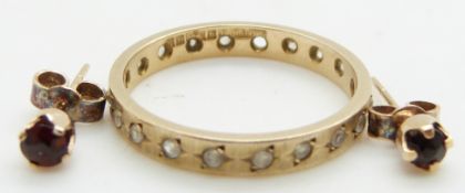A 9ct gold eternity ring (size N/O) and a pair of 9ct gold earrings set with a garnet to each, 2.8g