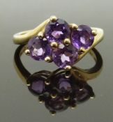 A 9ct gold ring set with four round cut amethysts, size K, 2.63g