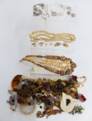 A collection of costume jewellery including butterfly filigree earrings, silver necklace marked