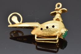 An 18k gold pendant/charm in the form of a helicopter and a hardstone cabochon, 4g