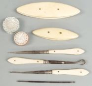 Sewing collectables to include two mother of pearl pin cushions, two ivory mounted winders and three