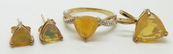 A 9ct gold ring (size M) set with a trillion cut Indonesian opal similar earrings, and a pendant