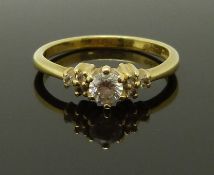 An 18ct gold ring set with a diamond of approximately 0.25ct and further diamonds to the