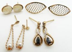 A pair of 9ct gold earrings set with a sapphire and diamonds, a pair of 9ct gold earrings set with
