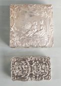 Two modern hallmarked silver trinket boxes, both with embossed decoration, one depicting a