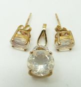 A 9ct gold pendant set with a round cut ice opal and diamonds with a pair of similar earrings, 3.5g
