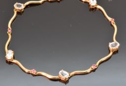 A 9ct gold bracelet set with oval cut aquamarine and pink topaz, 19cm, 5.6g