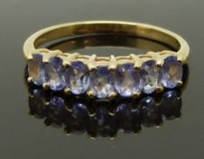 A 14K gold ring set with tanzanites, size P, 2.35g