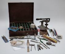 A collection of watch maker's tools, eye glasses etc together with a wooden fitted pocket watch