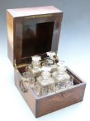 19thC liqeur set or travelling tantalus in fitted rosewood case, with four cut glass decanters and
