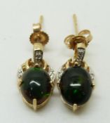 A pair of 9ct gold earrings set with an oval opal cabochon and diamonds to each, 2.1g