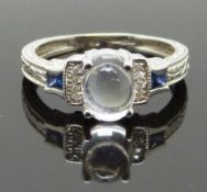 A 14k white gold ring set with a moonstone, sapphires and diamonds, size L/M, 3.17g