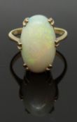 A 9ct gold ring set with a large opal cabochon, size L/M, 4.22g