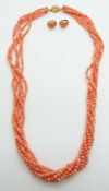 A five strand coral necklace with 18ct gold clasp and a pair of 18ct gold matching earrings