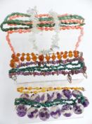 A collection of necklaces including beaded fluorite, aquamarine made up of natural uncut