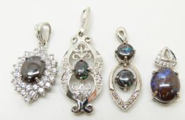 Four silver pendants set with boulder opal