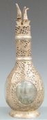 Hong Kong white metal mounted four compartment decanter, with pierced and embossed prunus
