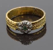 Georgian ring set with an emerald surrounded by old cut diamonds and plaited hair around the band,