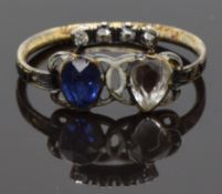 Georgian ring set with a foiled sapphire and paste with white enamel decoration and diamonds in a