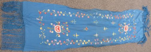 A 19th/20thC Chinese blue scarf with embroidered floral decoration and fringes, 180 x 45cm including