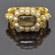 Georgian mourning ring set with plaited hair to the centre surrounded by seed pearls, with