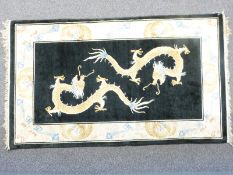 Chinese style rug with two golden dragons in central field surrounded by cream ground floral /