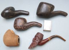 Four cased carved figural Meerschaum pipes including one with armorial or crest, three with amber