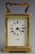H.Samuel 20thC brass carriage clock in corniche style case, the painted white Roman dial with Arabic