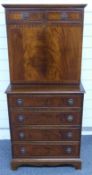 Mahogany secretaire chest of two over four drawers either side of a cabinet, opening to reveal a