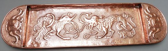 Arts and Crafts copper tray with hammered decoration of mythical creatures, length 77cm